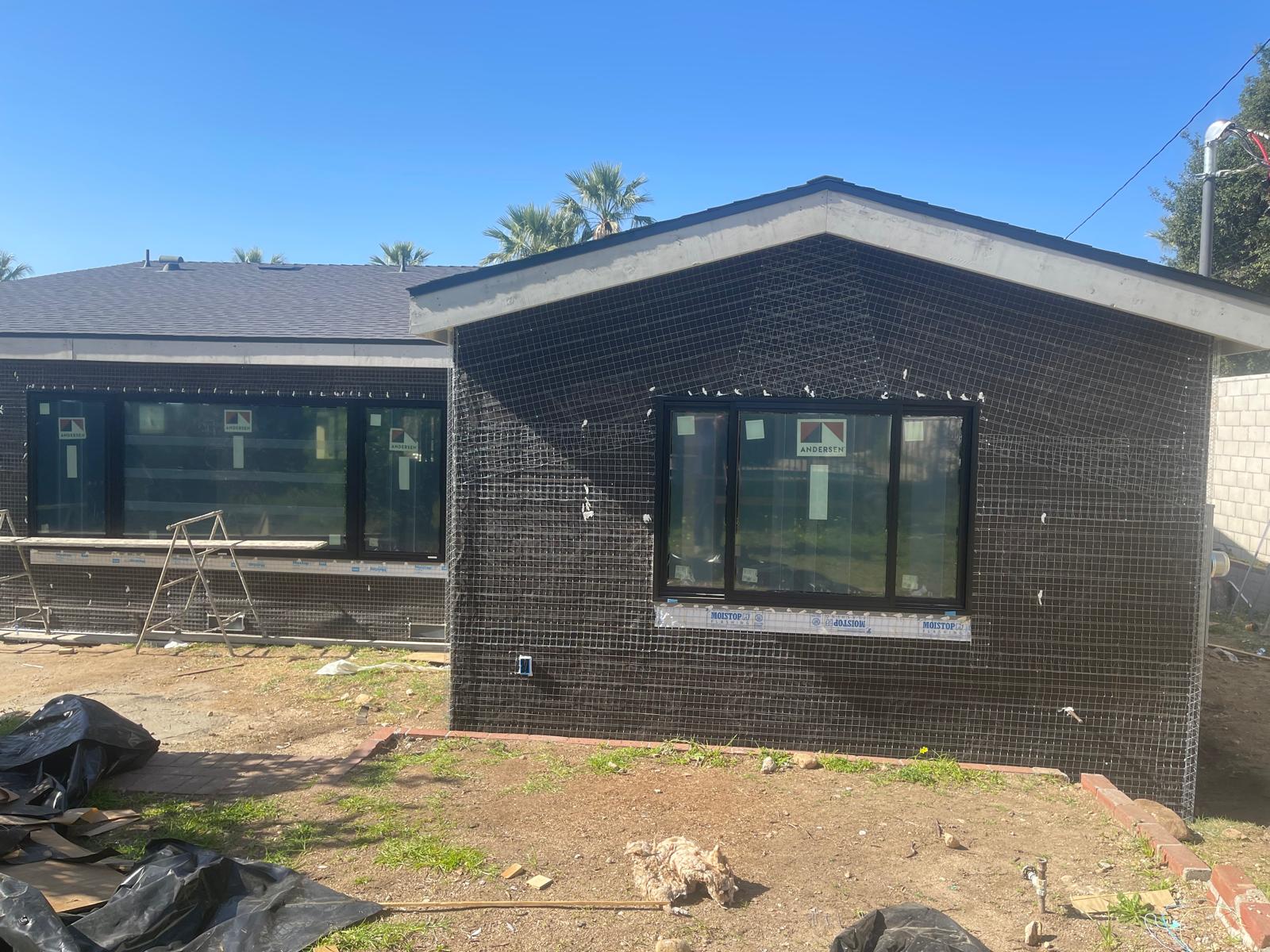 ADU construction in progress with stucco lath and Andersen windows - Luz Builders