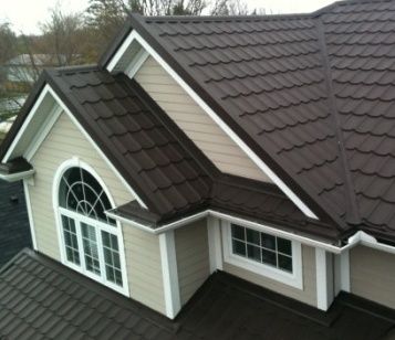 Metal tile roof installation with dark brown hip roof and dormers in Los Angeles